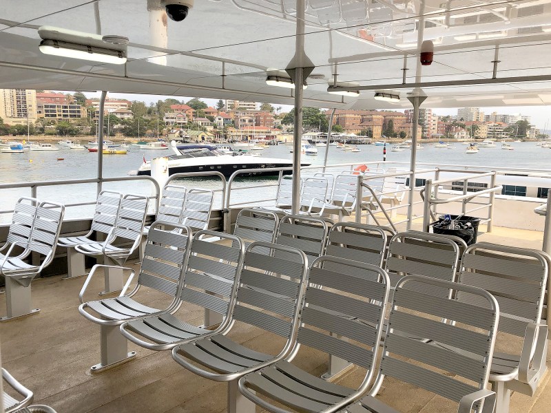a bird sitting on top of a metal fence