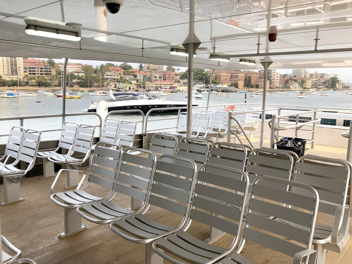 a bird sitting on top of a metal fence
