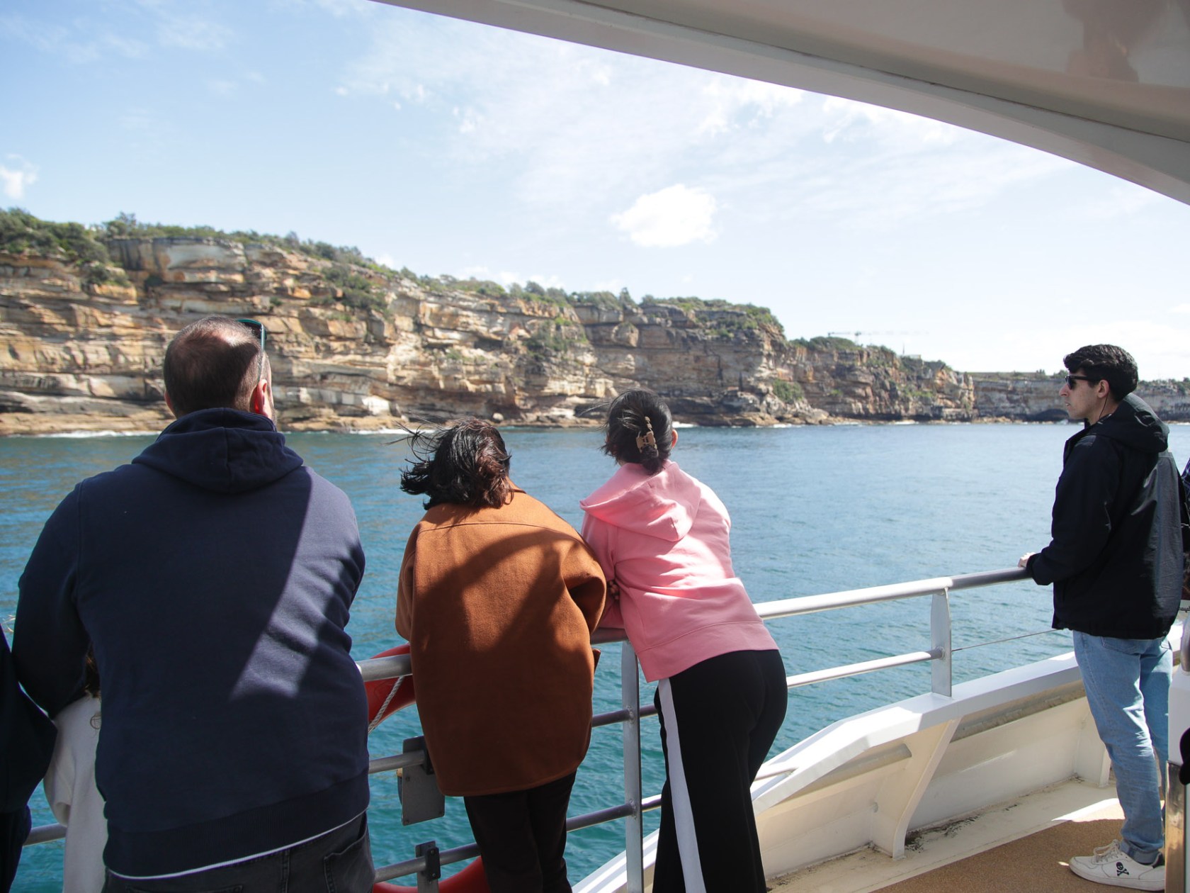 a group of people standing next to a body of water