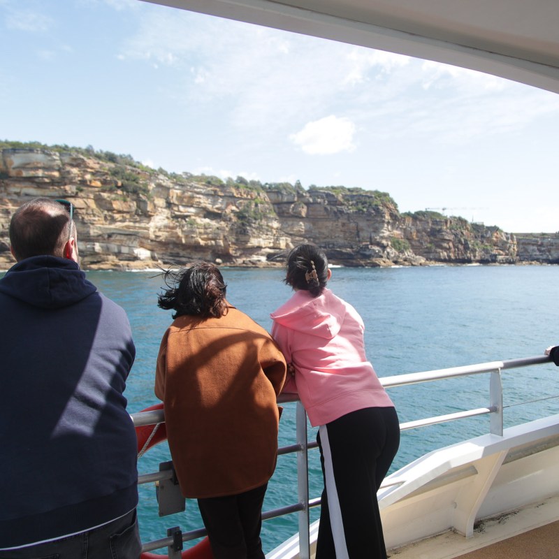 a group of people standing next to a body of water