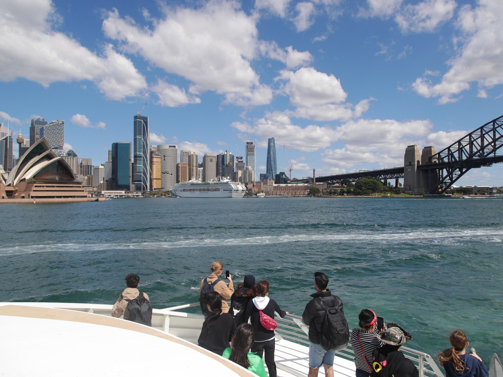 a group of people on a bridge over a body of water