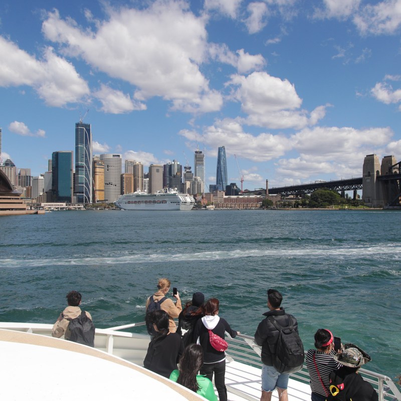 a group of people on a bridge over a body of water