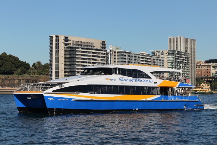a large blue boat sitting next to a body of water