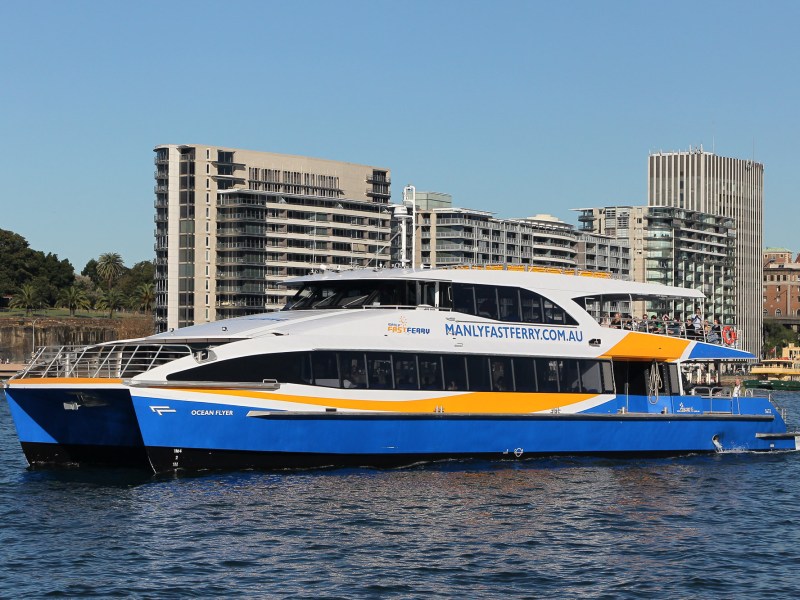 a large blue boat sitting next to a body of water