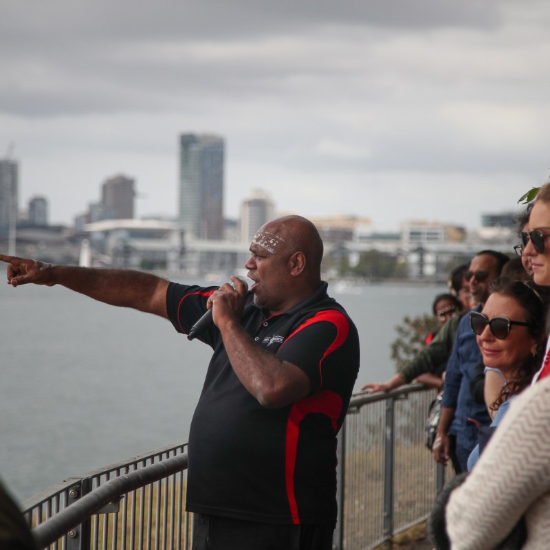 a group of people looking at a cell phone