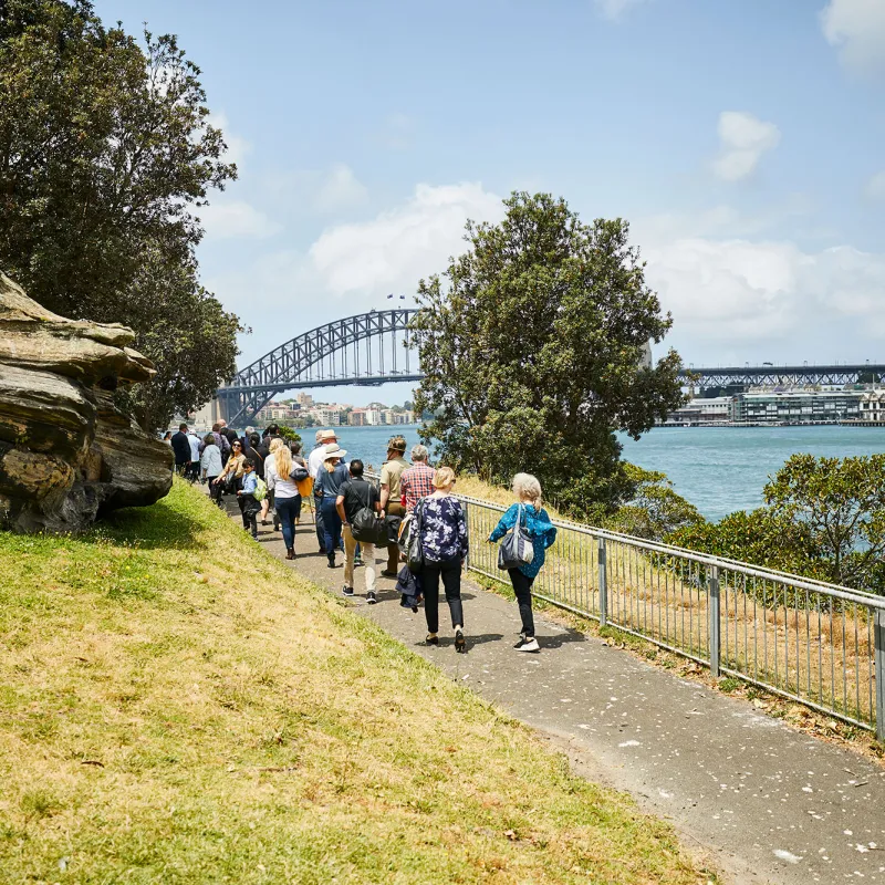 a group of people standing next to a fence