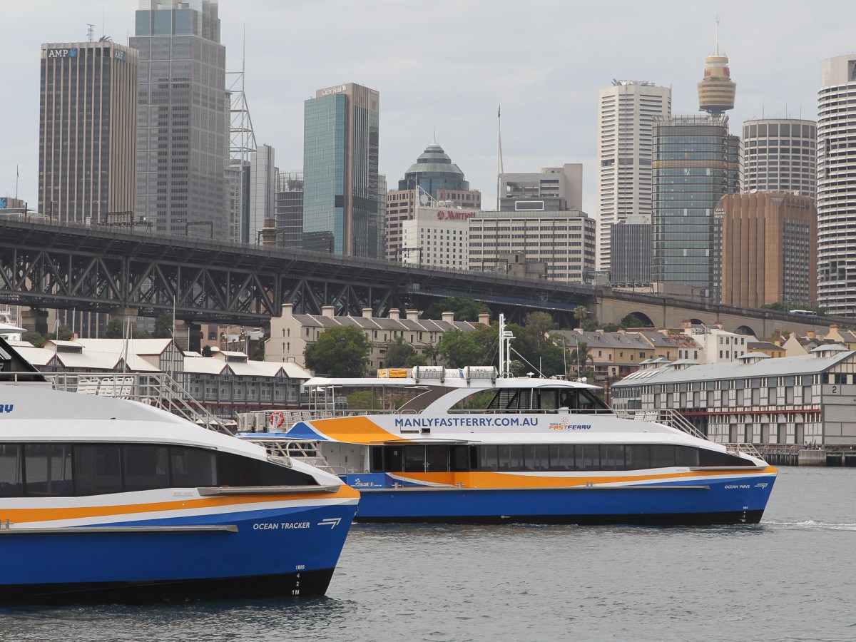 a large blue boat sitting next to a body of water