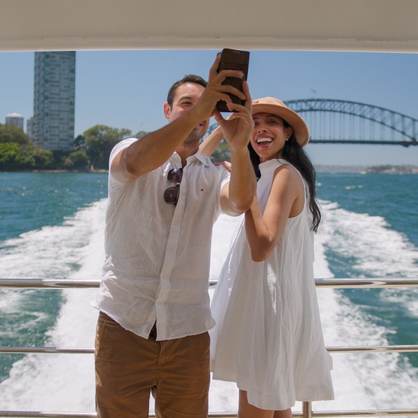 a man standing in front of a body of water