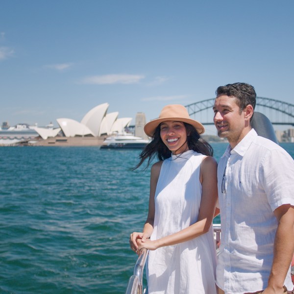 a man standing next to a body of water