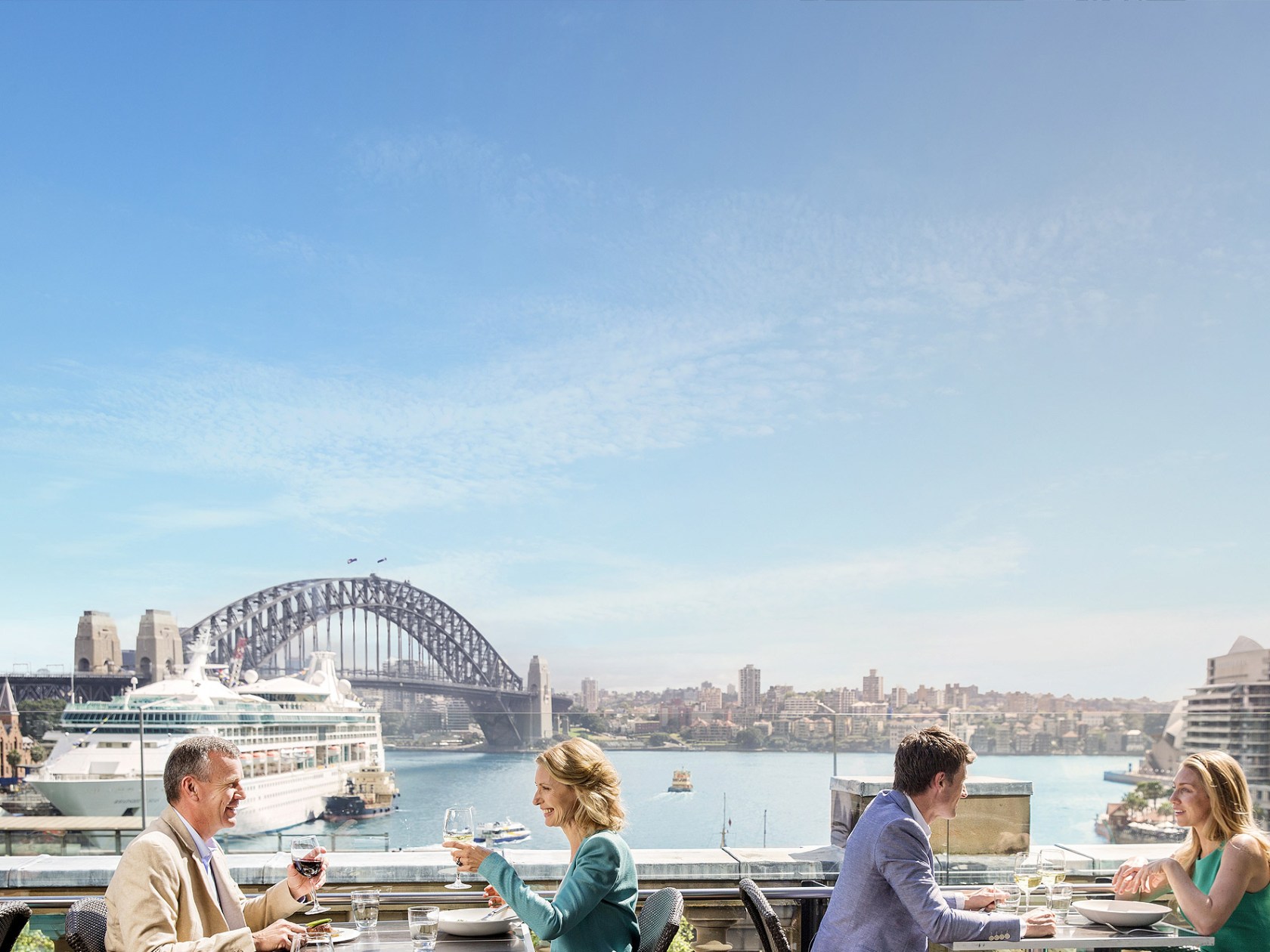 a group of people sitting at a dock