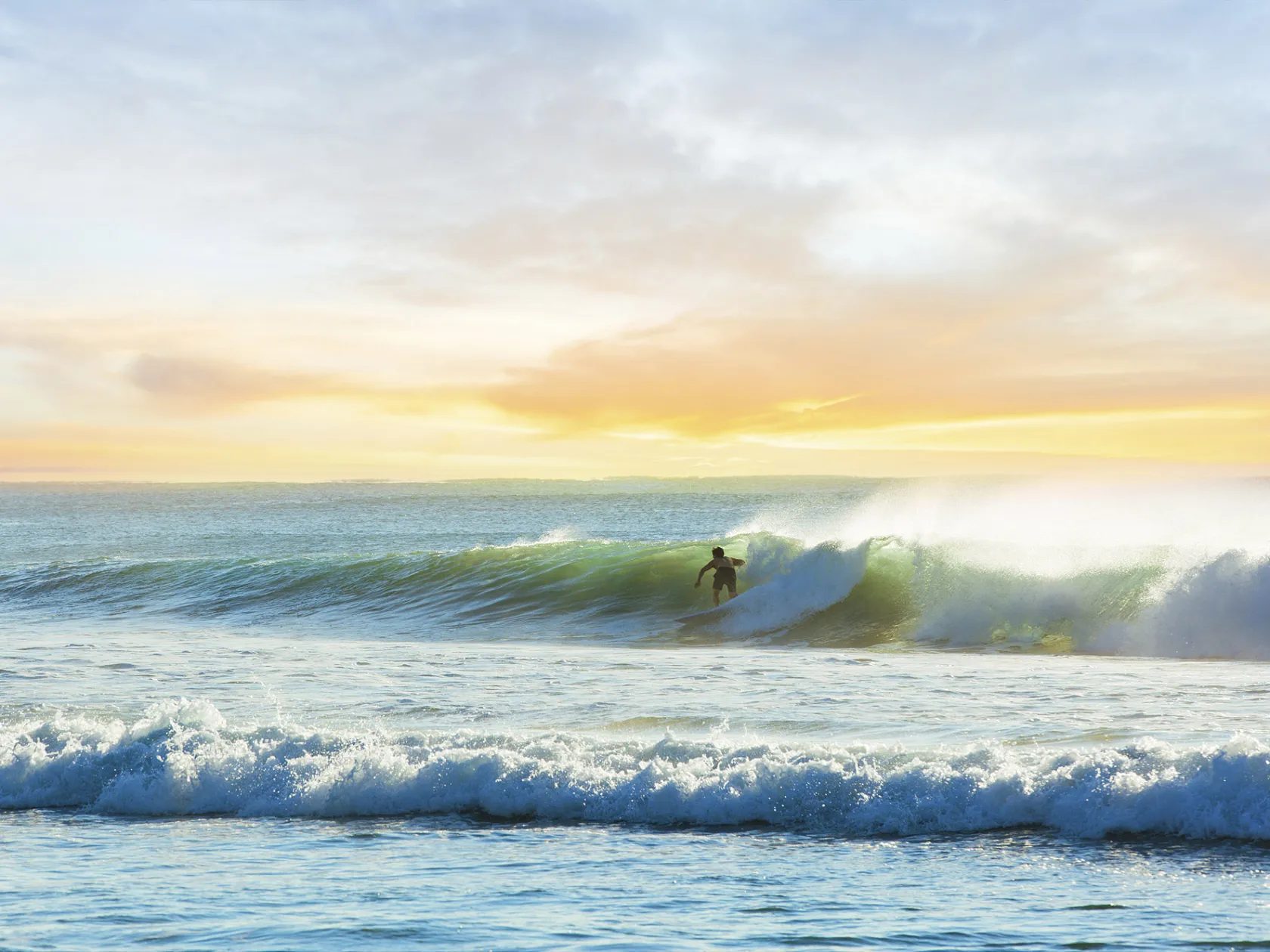 a person riding a wave on top of a body of water