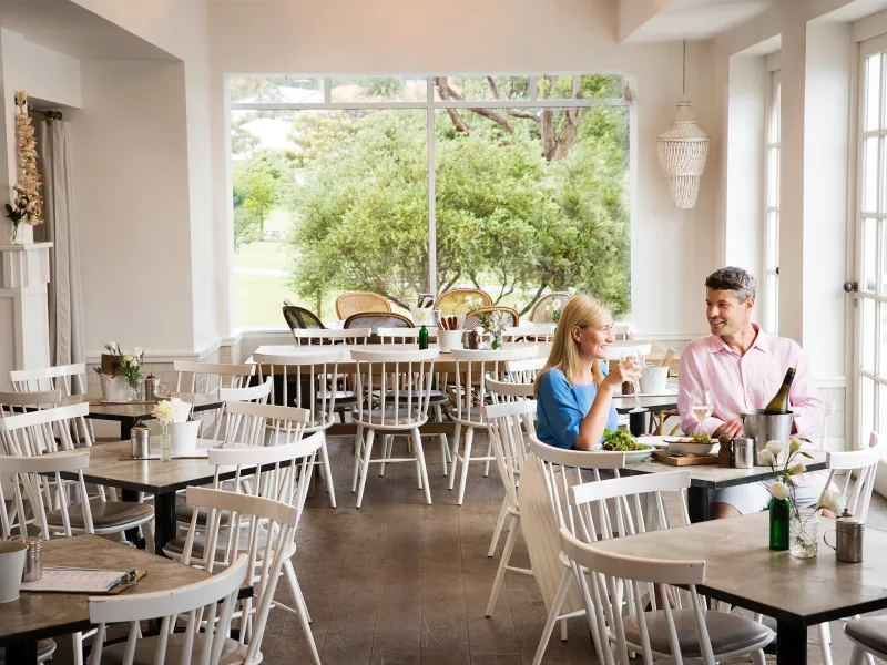a dining room table in front of a window