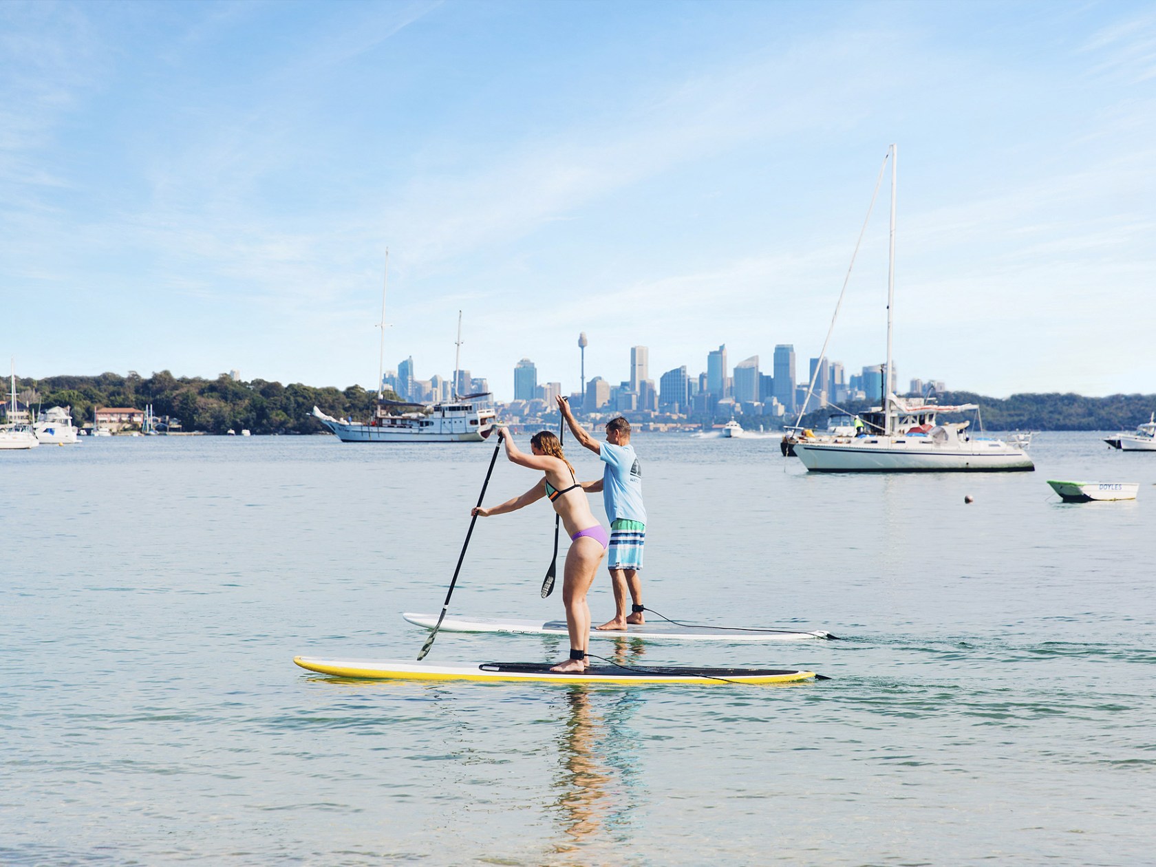 a man riding on the back of a boat in a body of water
