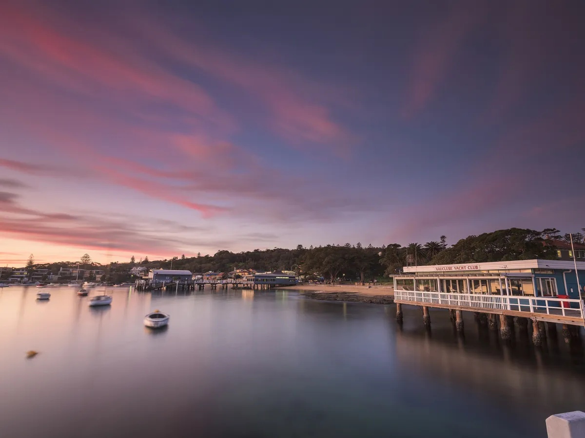 a boat is docked next to a body of water