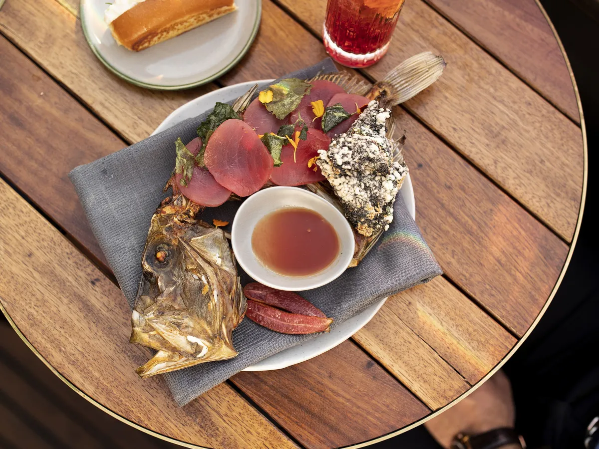 a plate of food sitting on top of a wooden table