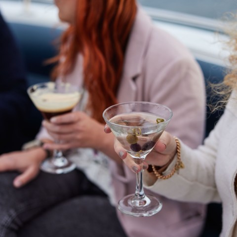 a person drinking a glass of wine