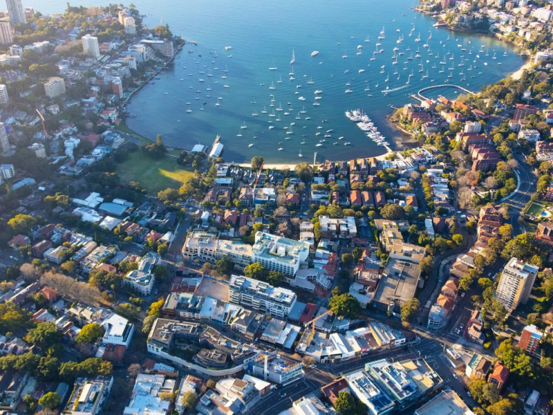 a large body of water with a city in the background
