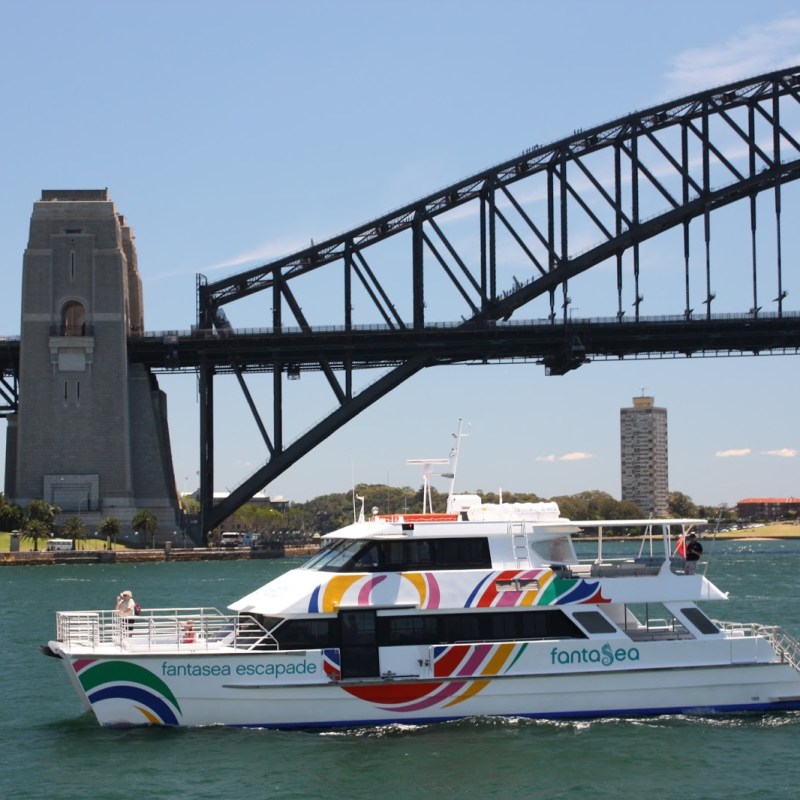 a boat traveling across a bridge over a body of water