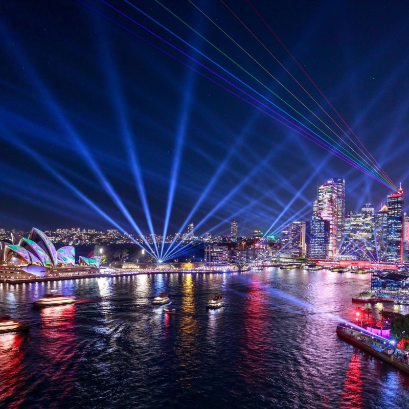 a bridge over a body of water with a city in the background