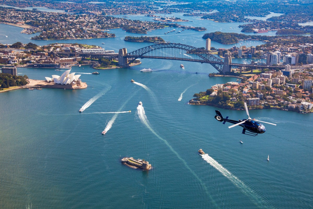 a small boat in a body of water with a city in the background