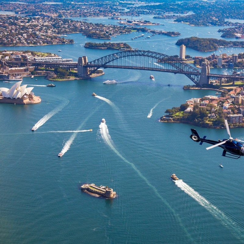 a small boat in a body of water with a city in the background
